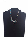 Necklace silver and little stones in blue light