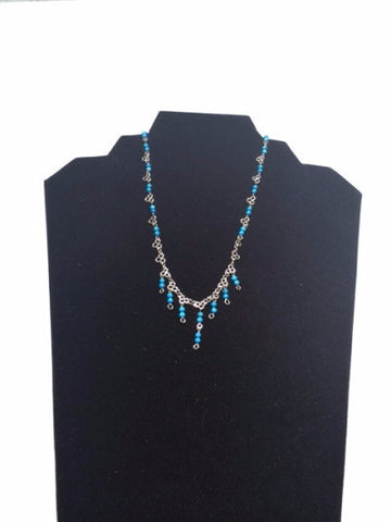 Necklace silver and little stones in blue light